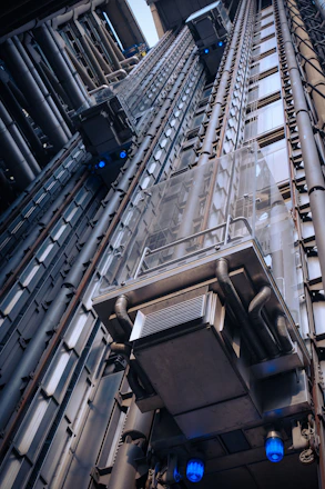 A sleek modern elevator shaft with technicians installing advanced elevator components.
