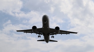 a large jetliner flying through a cloudy blue sky