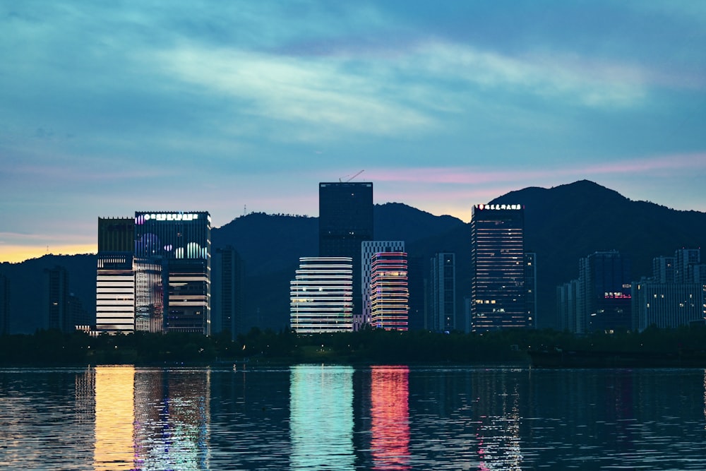 a city skyline is reflected in a body of water