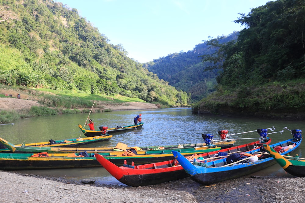 a group of boats floating on top of a river