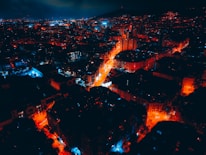 Aerial night view of Sofia skyline with subtle aurora light effects in the sky.