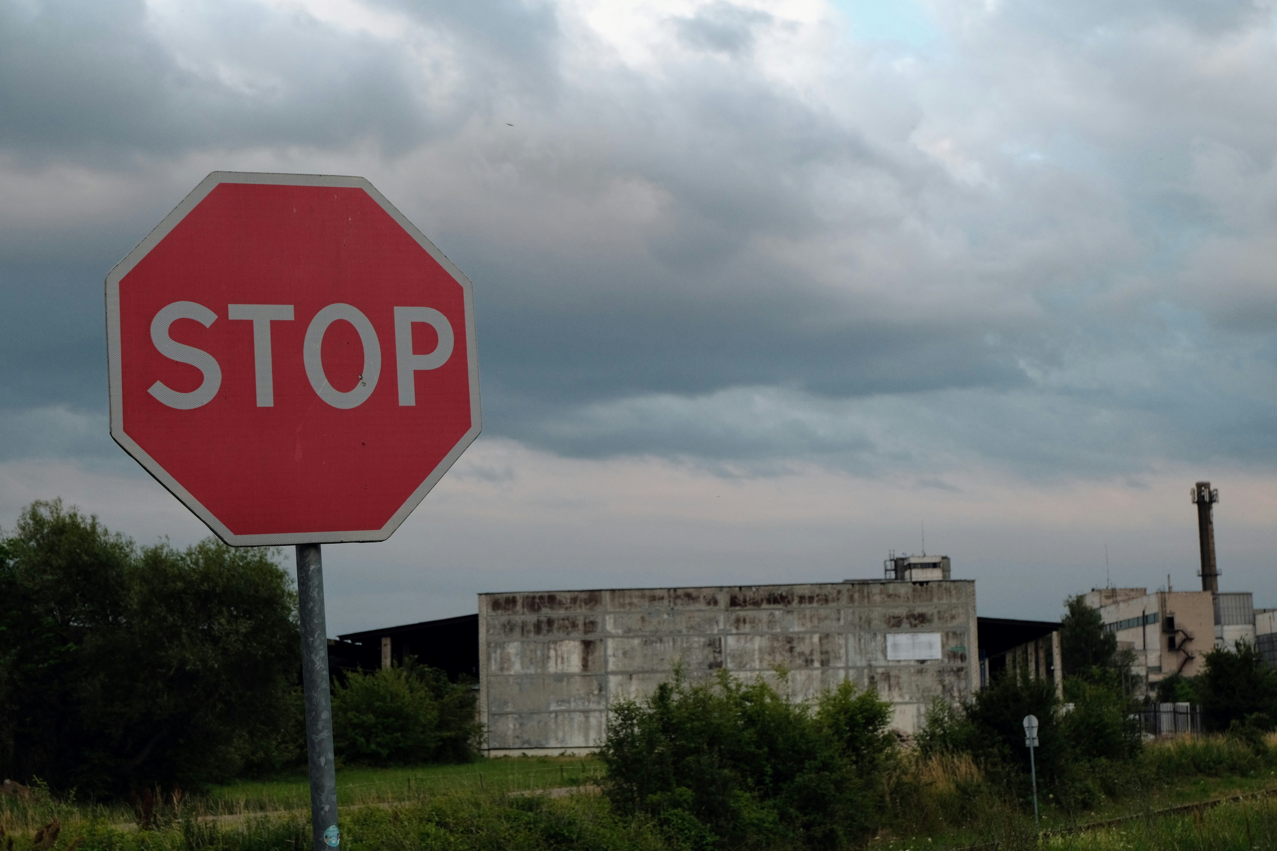 a red stop sign sitting on the side of a road