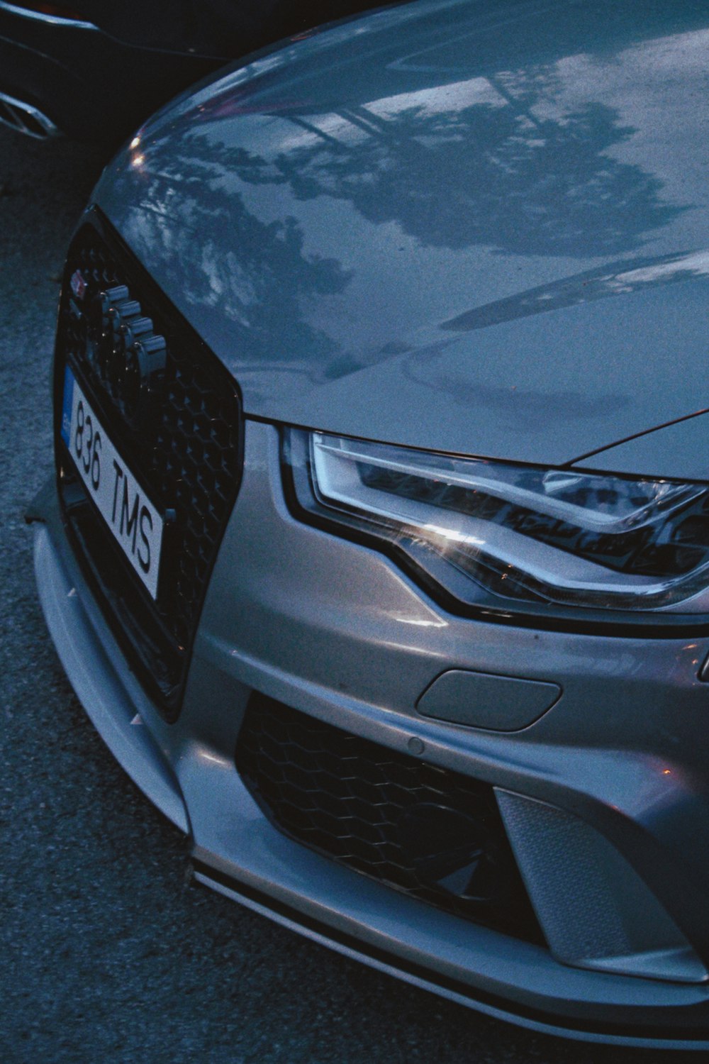 a silver car parked on the side of the road