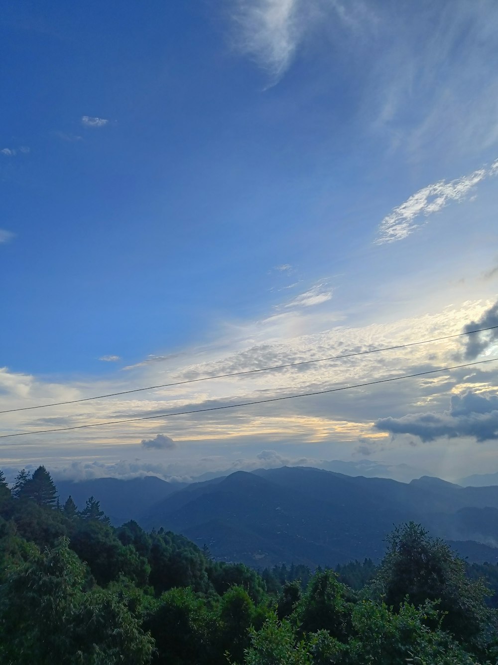 a scenic view of a mountain range with clouds in the sky