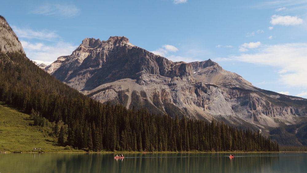 a mountain range with a lake in the foreground