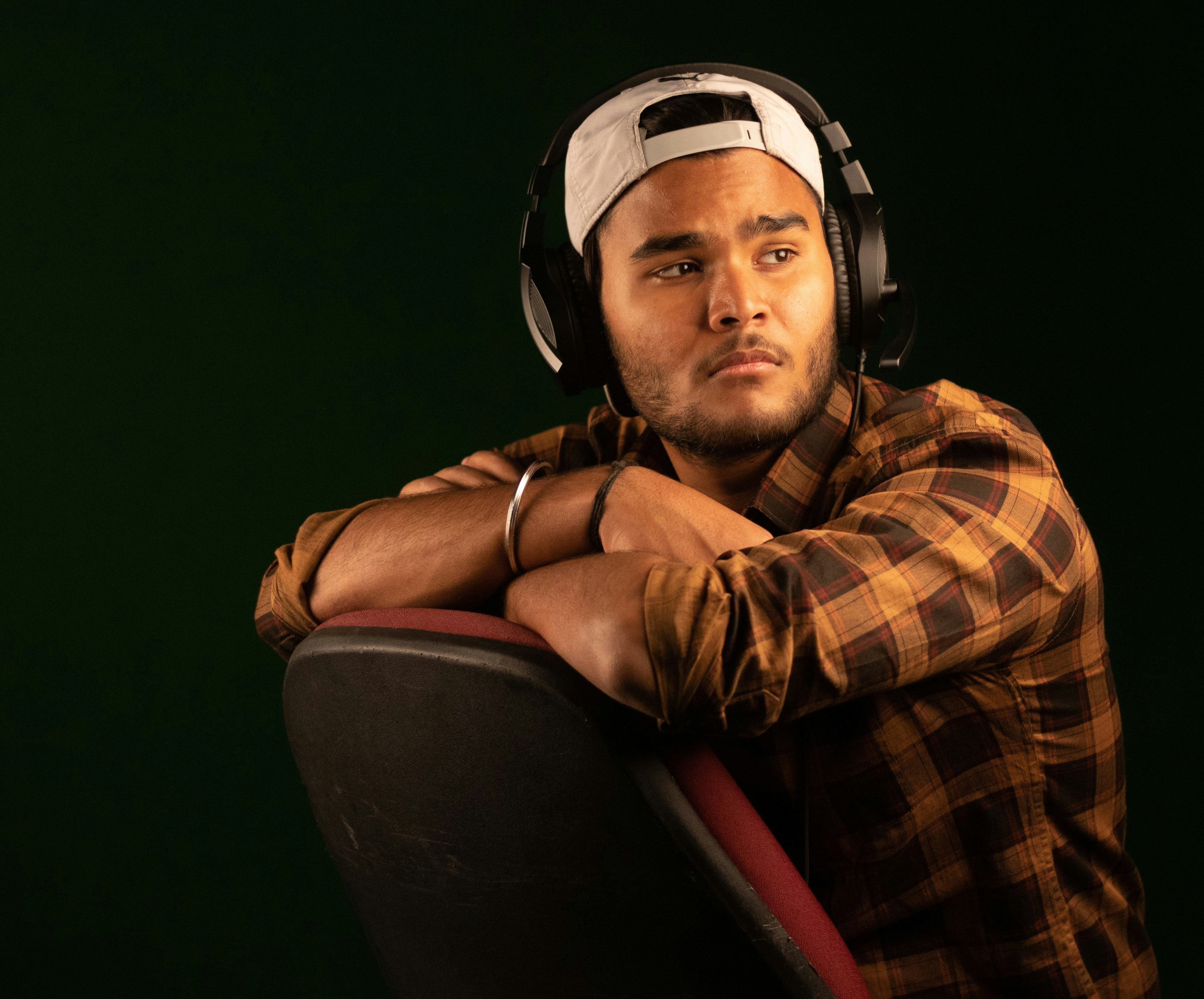 a man wearing headphones sitting in a chair