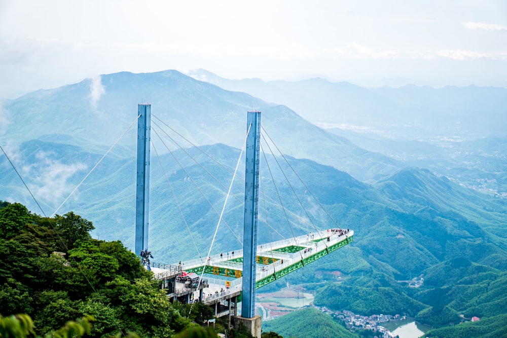 a bridge that is suspended over a mountain
