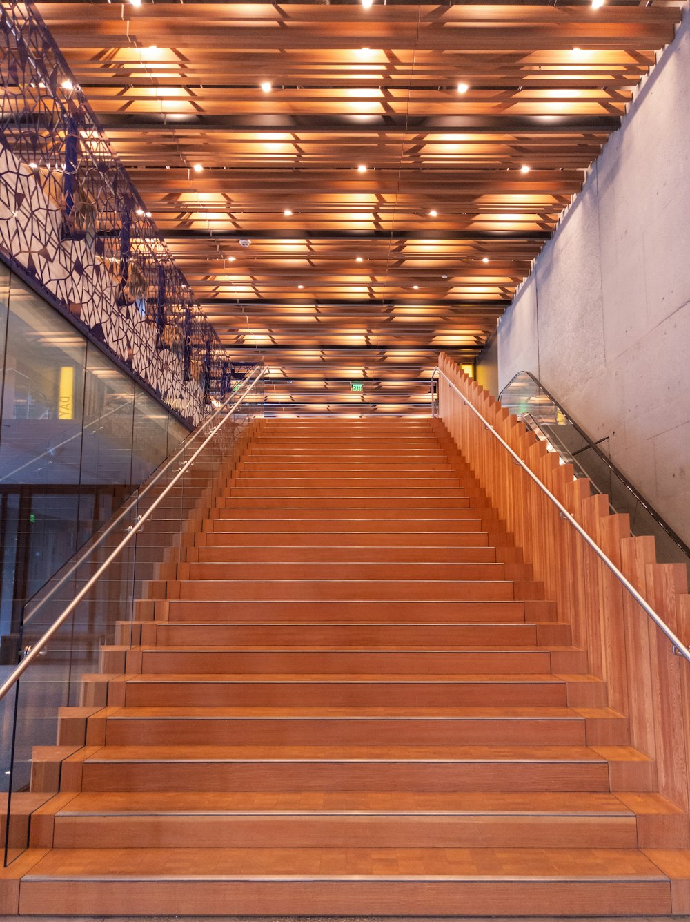 a set of wooden stairs leading up to an escalator