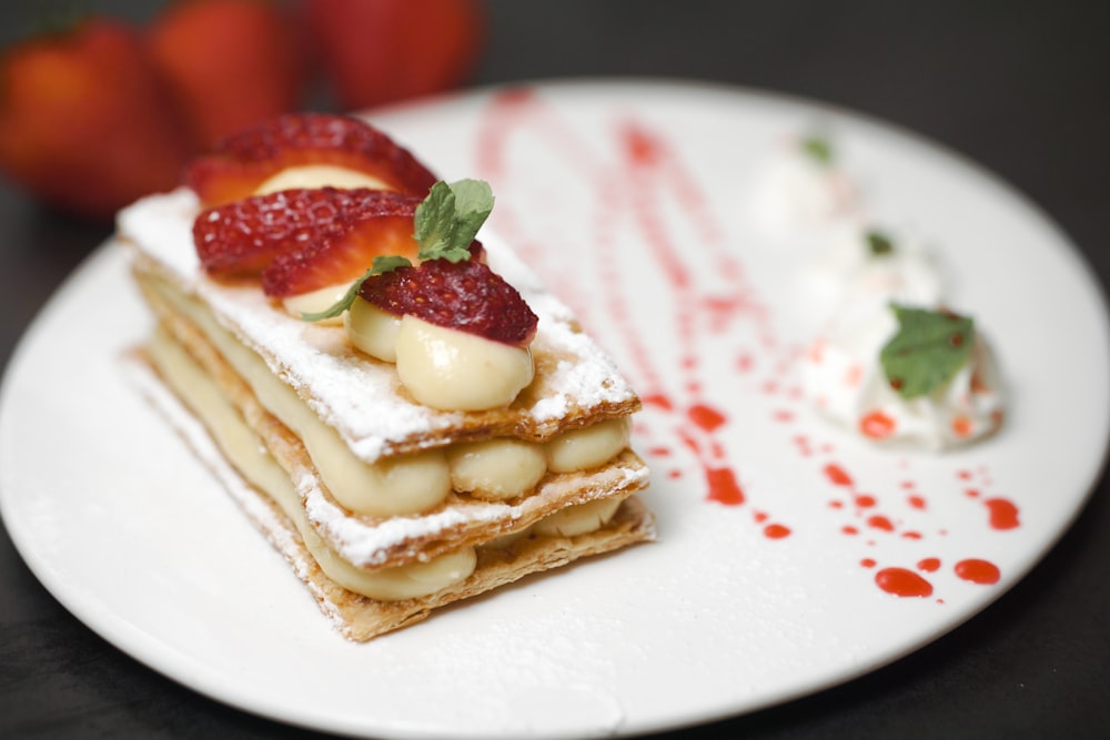 a white plate topped with a piece of cake