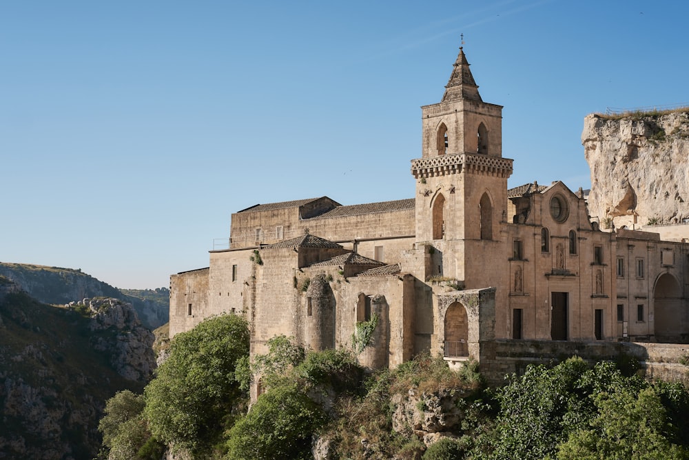 a large building with a tower on top of a cliff