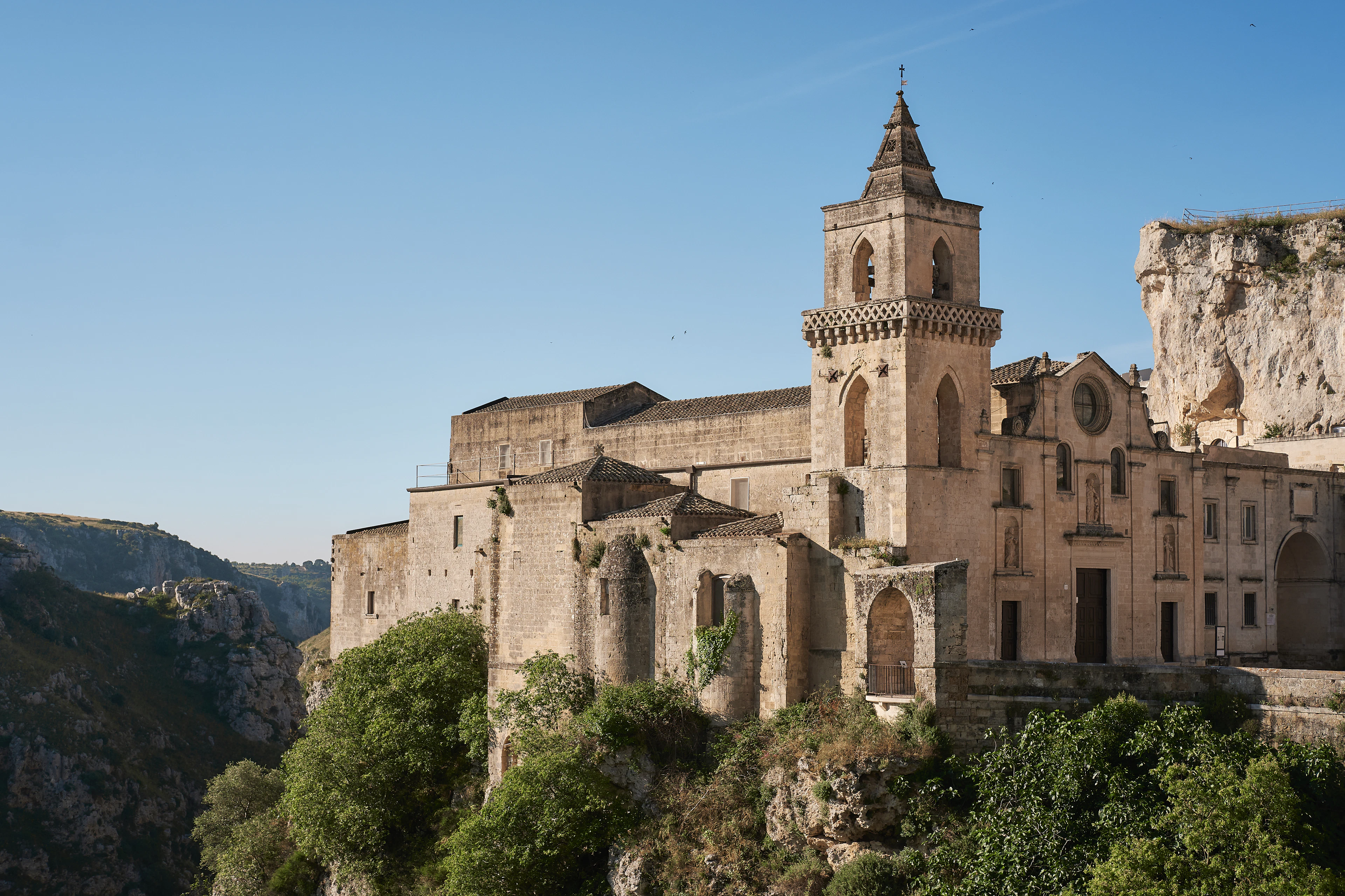 The church of San Pietro Caveoso and its bell tower perched on the edge of the Gravina ravine in Matera