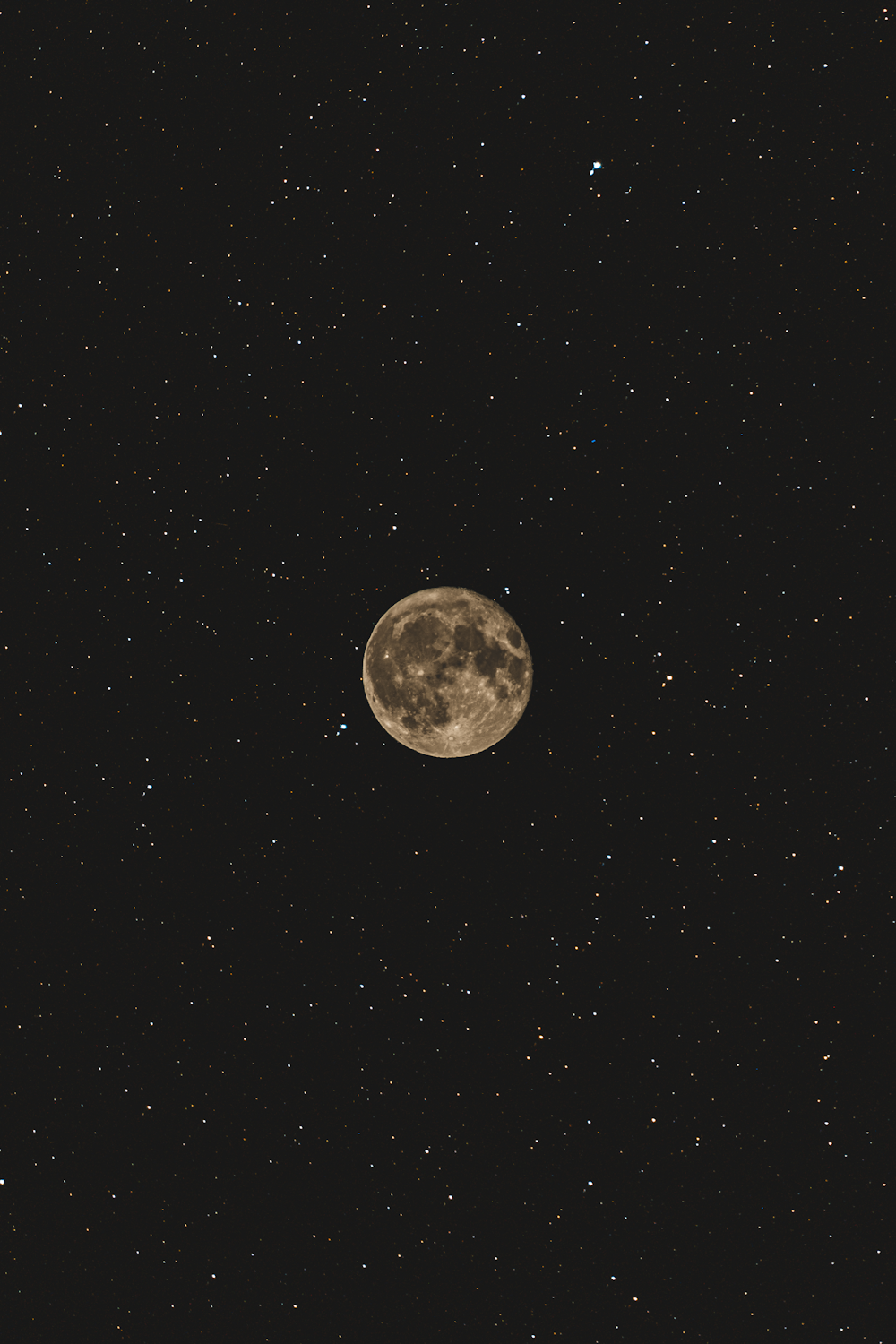 a full moon in the night sky with stars