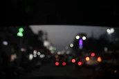 Nighttime cityscape with discreet surveillance cameras capturing activity under soft lighting.