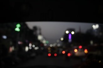 A blurred cityscape at night with glowing lights and a calm atmosphere.