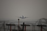 a large jetliner flying through a foggy sky