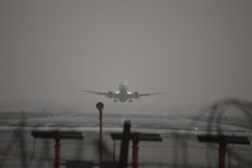a large jetliner flying through a foggy sky