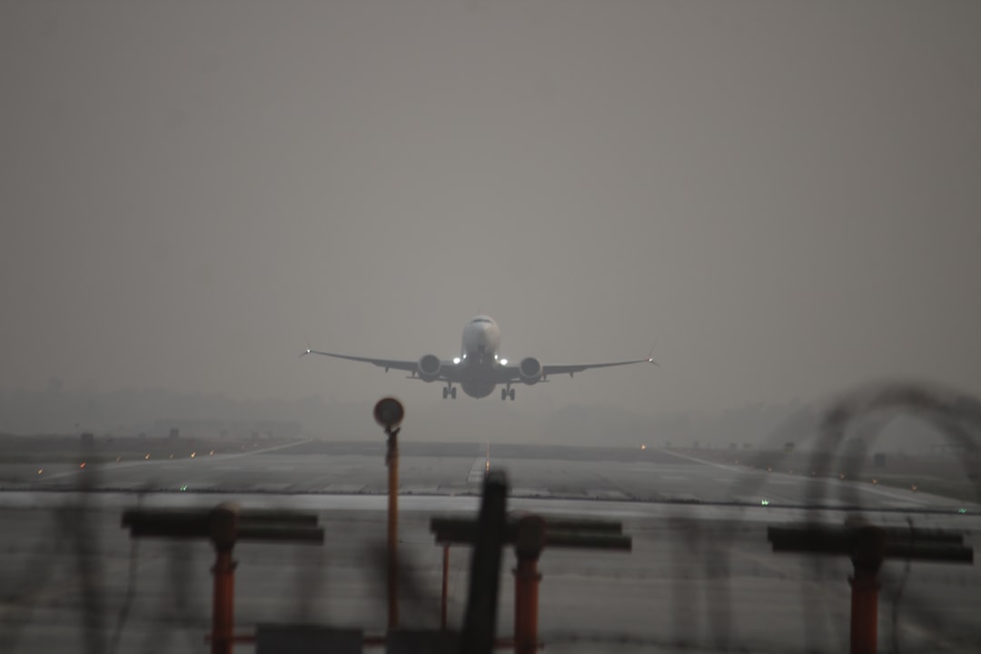 a large jetliner flying through a foggy sky,