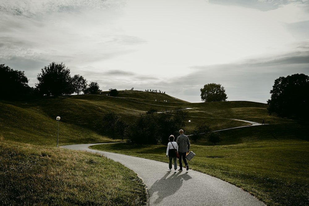 a couple of people that are walking down a path