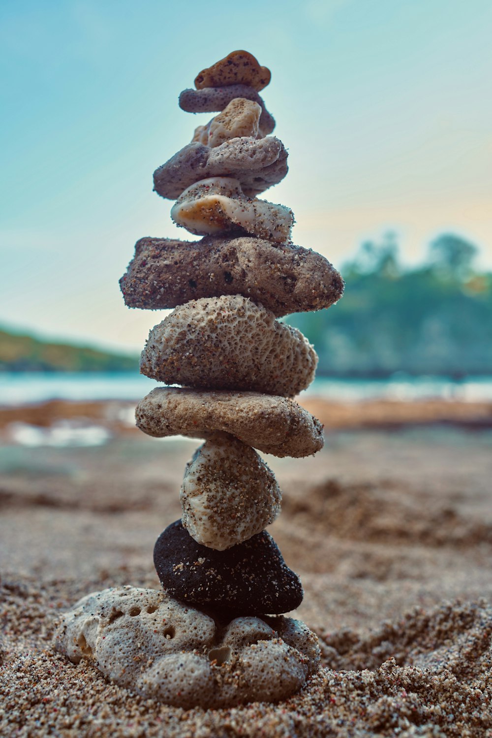 a stack of rocks sitting on top of a sandy beach