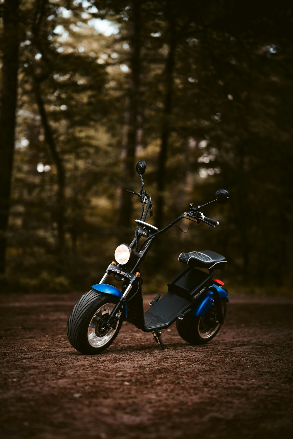 a motorcycle parked in the middle of a forest