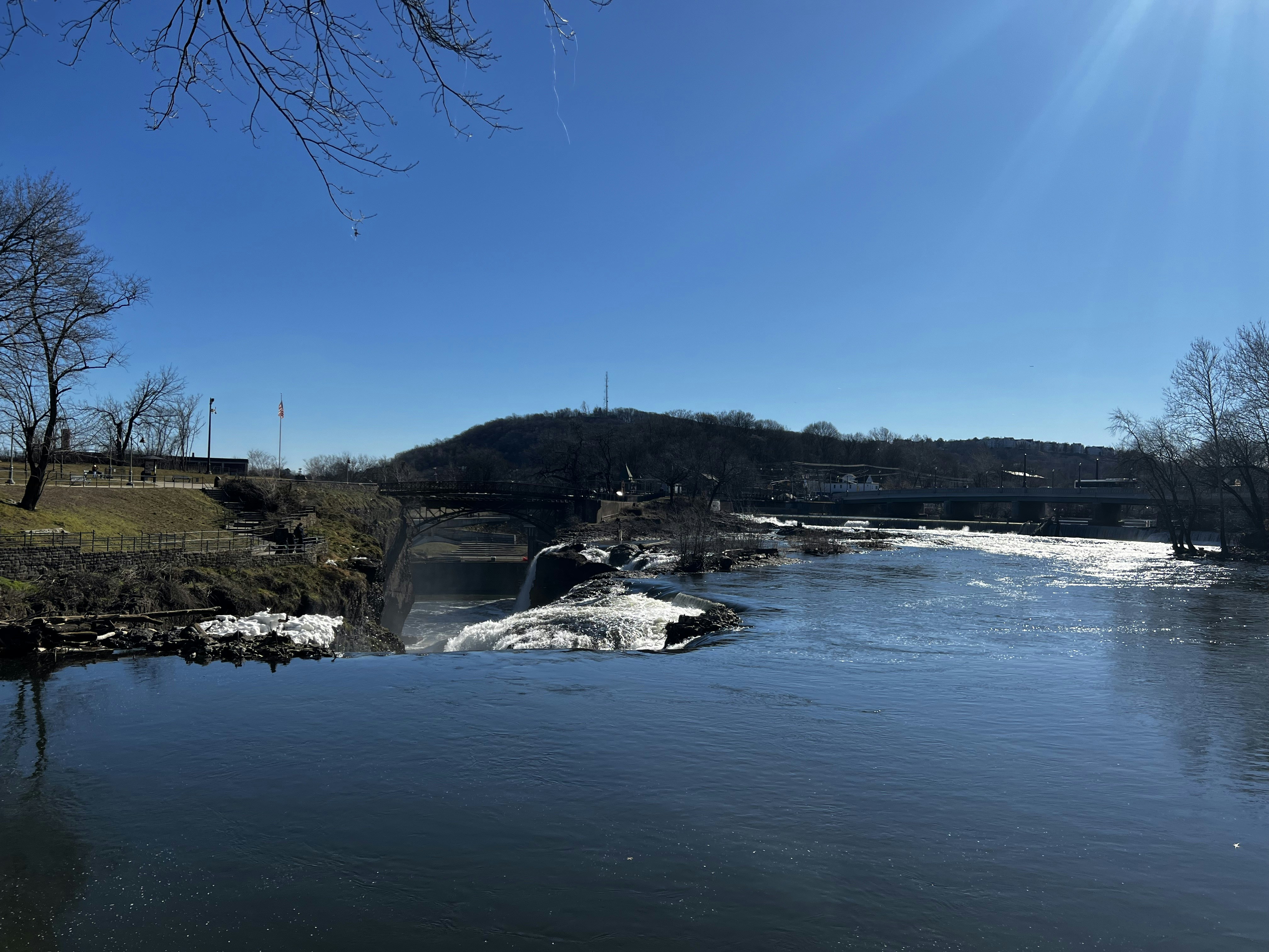 a view of a river with a bridge in the background