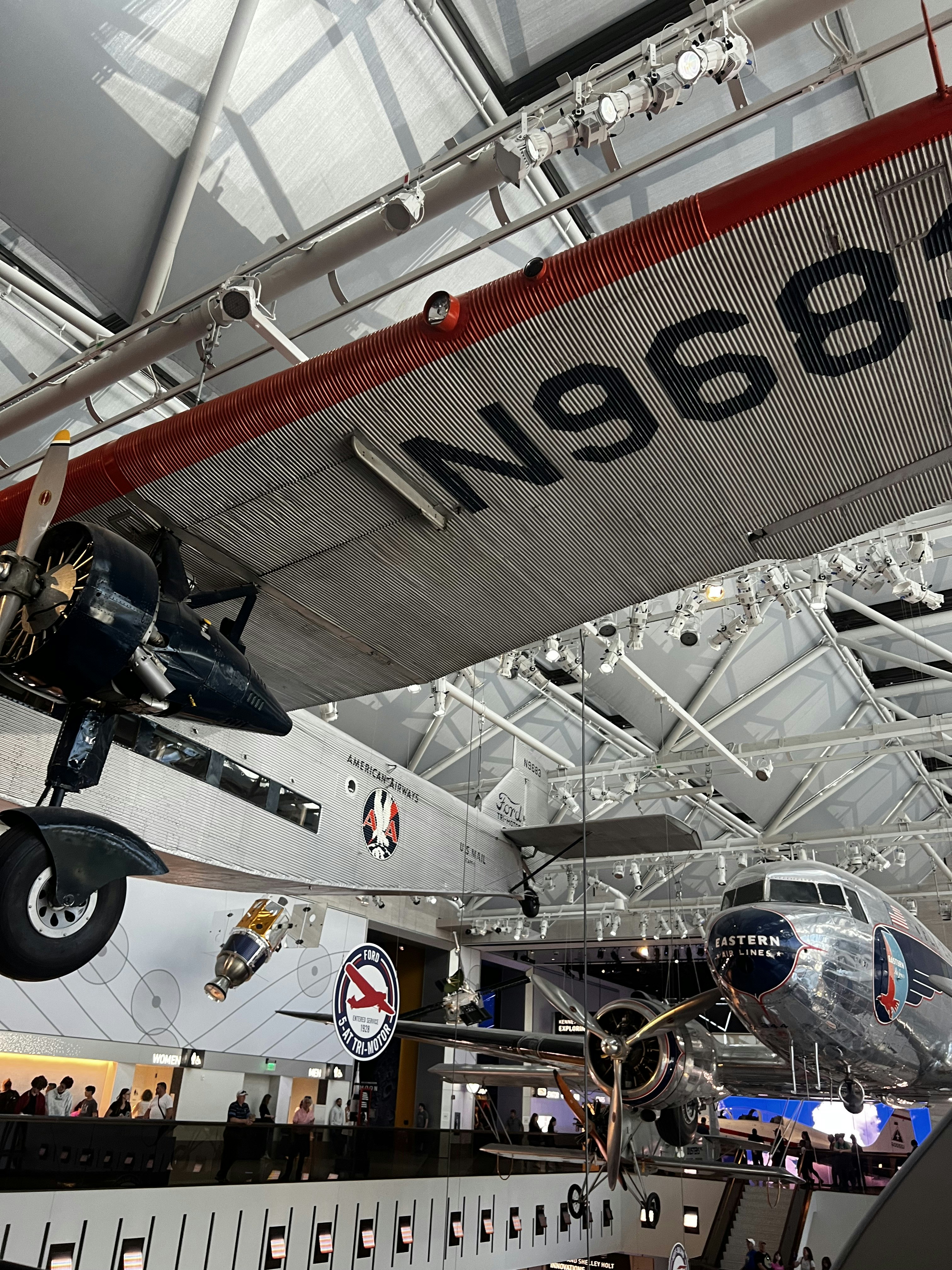 an airplane hanging from the ceiling of a museum