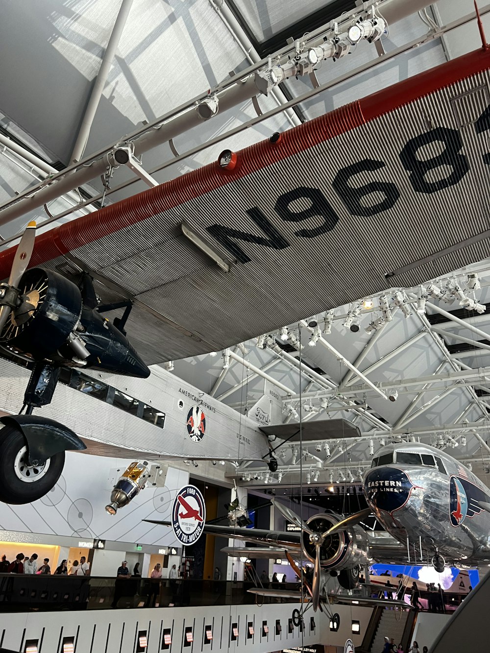 an airplane hanging from the ceiling of a museum