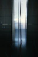 Blurred architectural video background showing natural light filtering through modern structural elements.