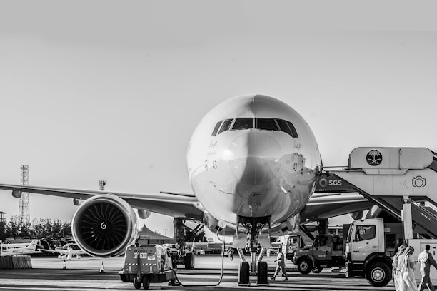 Technicians inspecting airplane landing gear on the tarmac