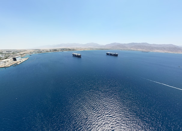 An expansive view of the Basra coastline with ships docked.
