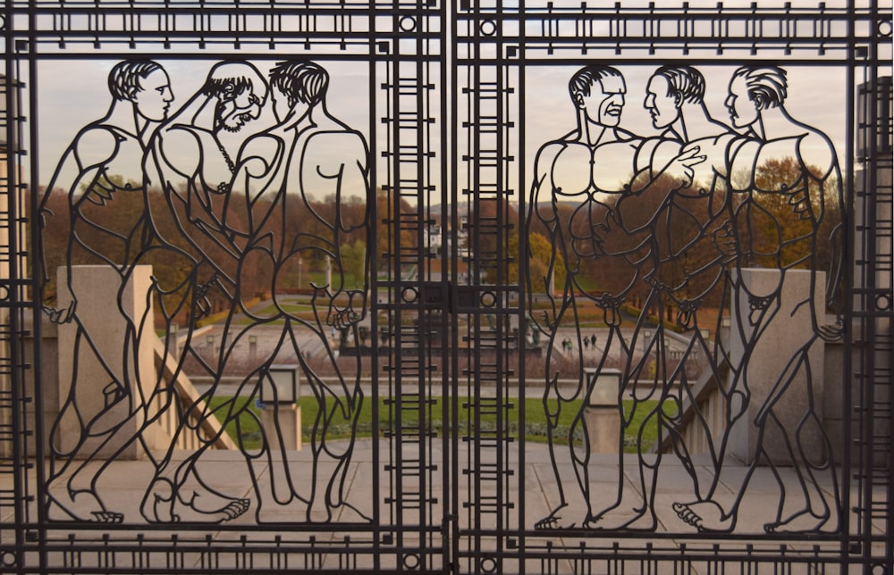 a metal gate with a picture of people on it