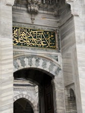 Close-up of golden leaf applied delicately on mosque arch molding.