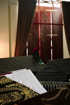 A cinematic scene from an Arabic drama featured on Donasy, with rich deep red and black tones.