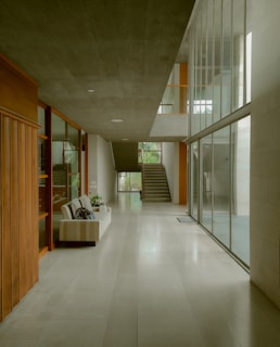 a long hallway with a couch and stairs