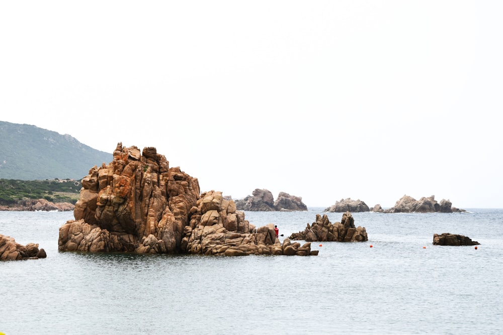 a group of rocks in the middle of a body of water