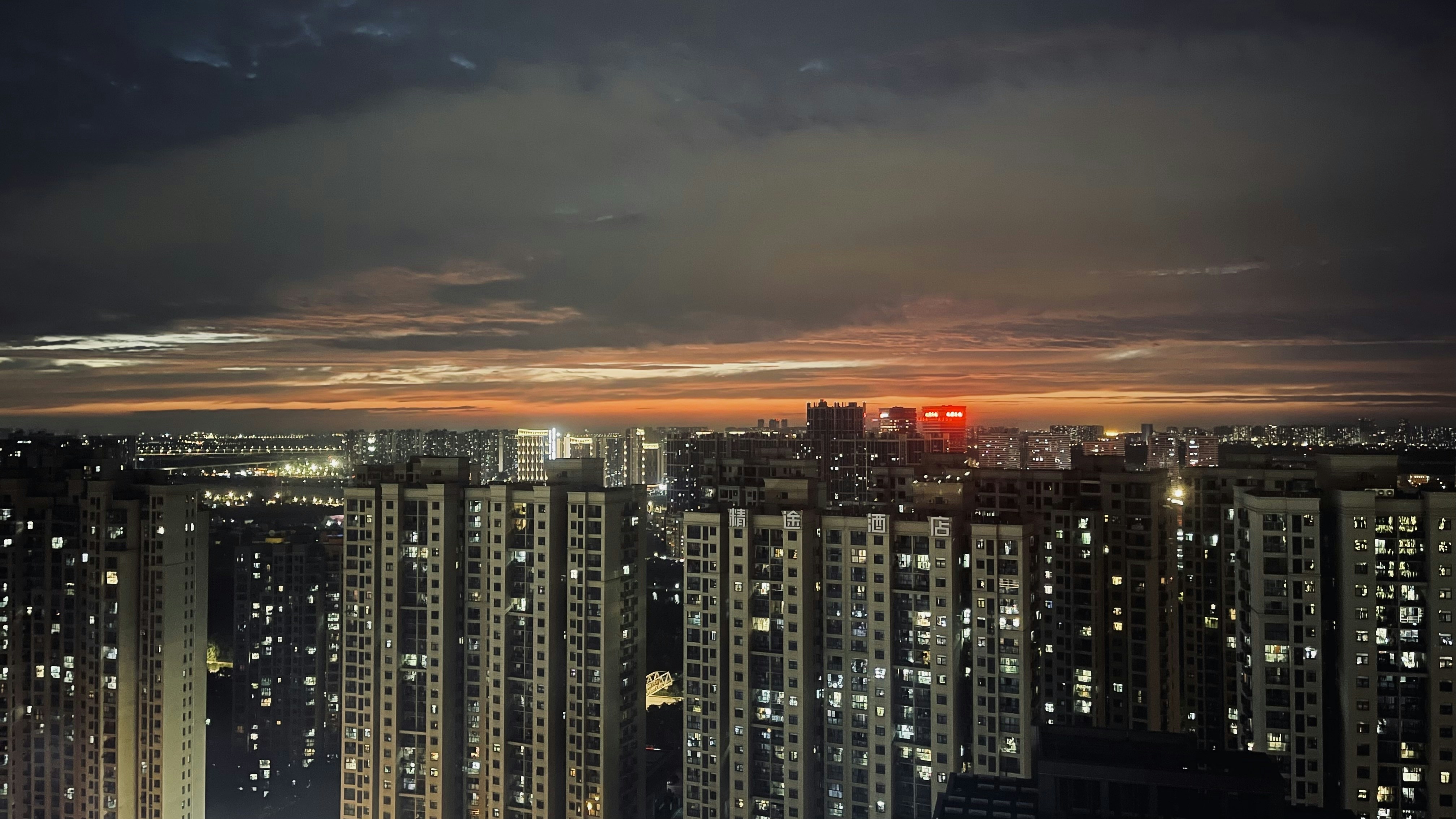 a view of a city at night from the top of a building