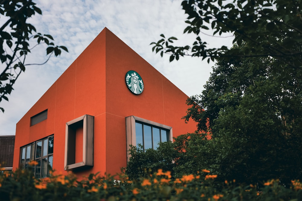 an orange building with a starbucks sign on it