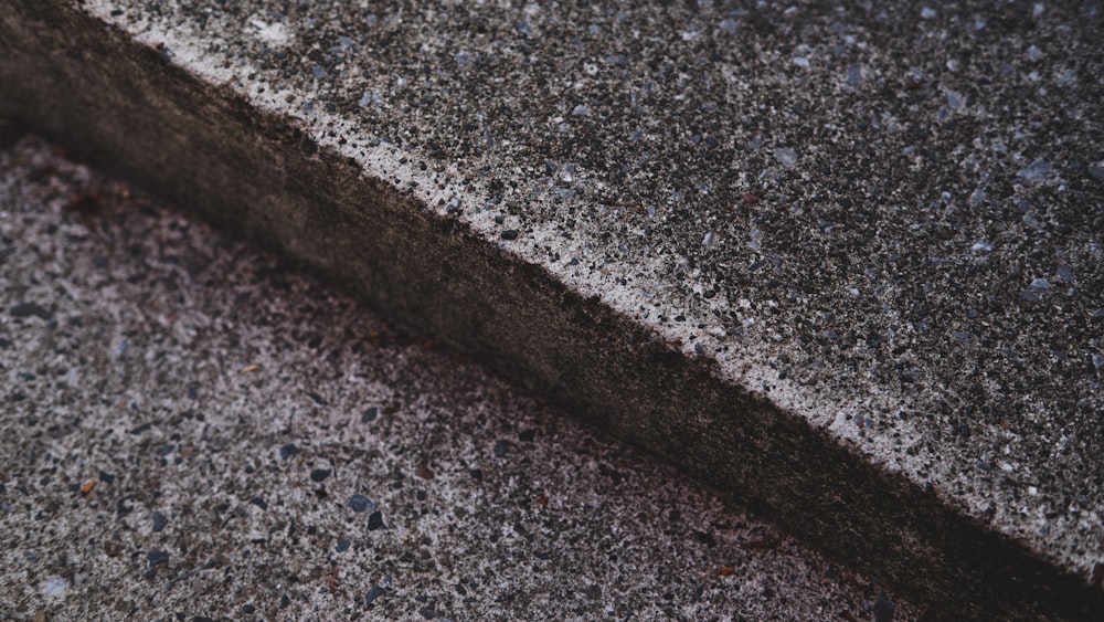 a close up of a street curb with a stop sign on it