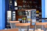 a restaurant with chairs and signs on the wall