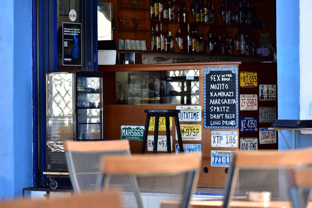 a restaurant with chairs and signs on the wall