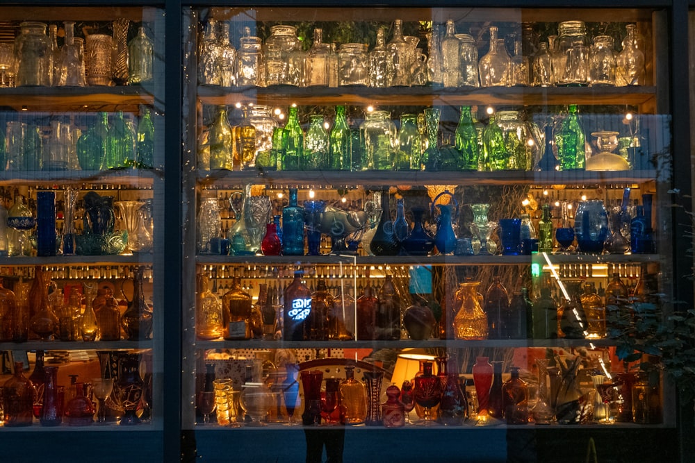 a display case filled with lots of glass bottles
