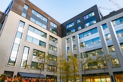 a large building with many windows next to a street