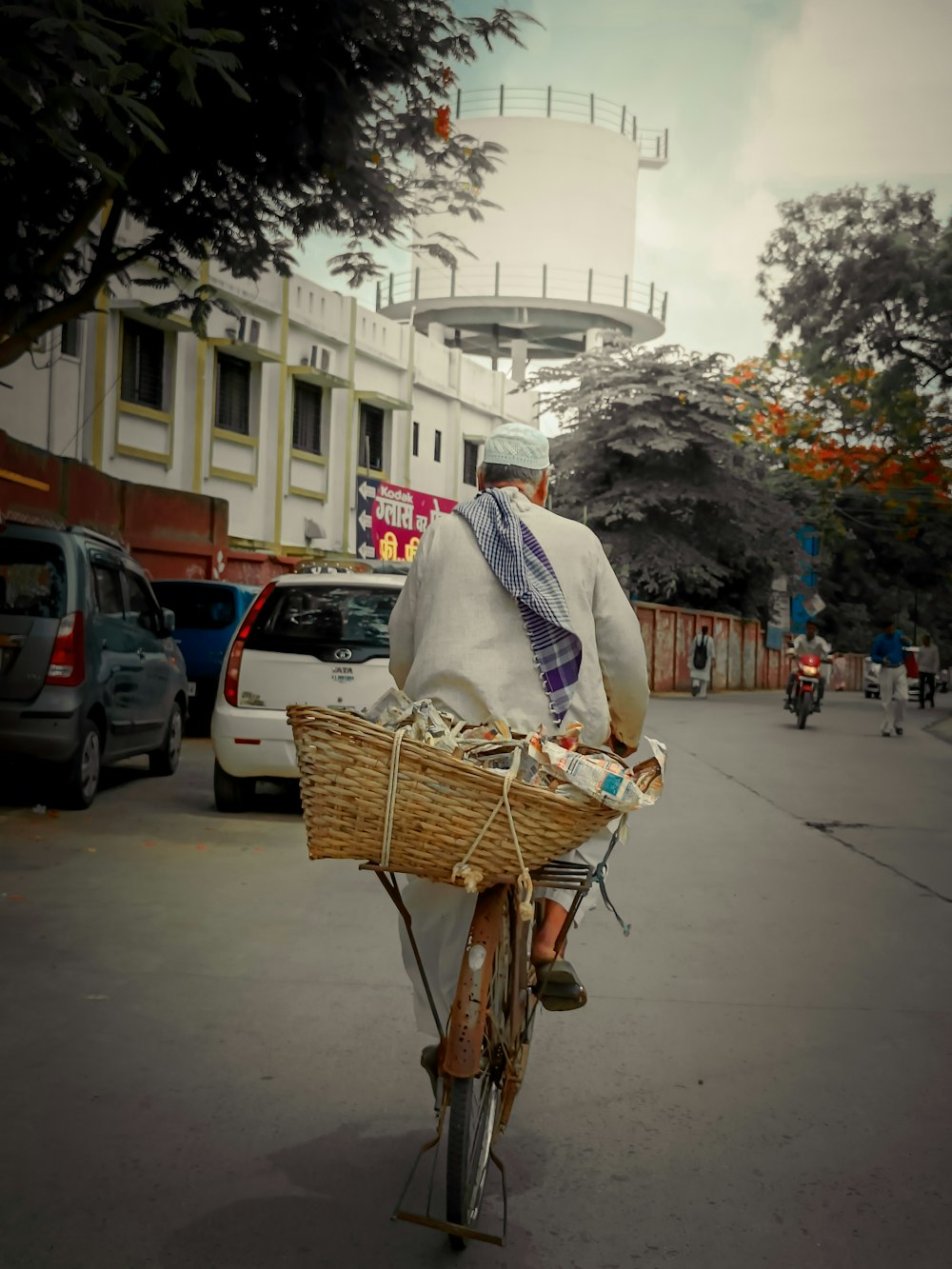 a man riding a bike with a basket on the back