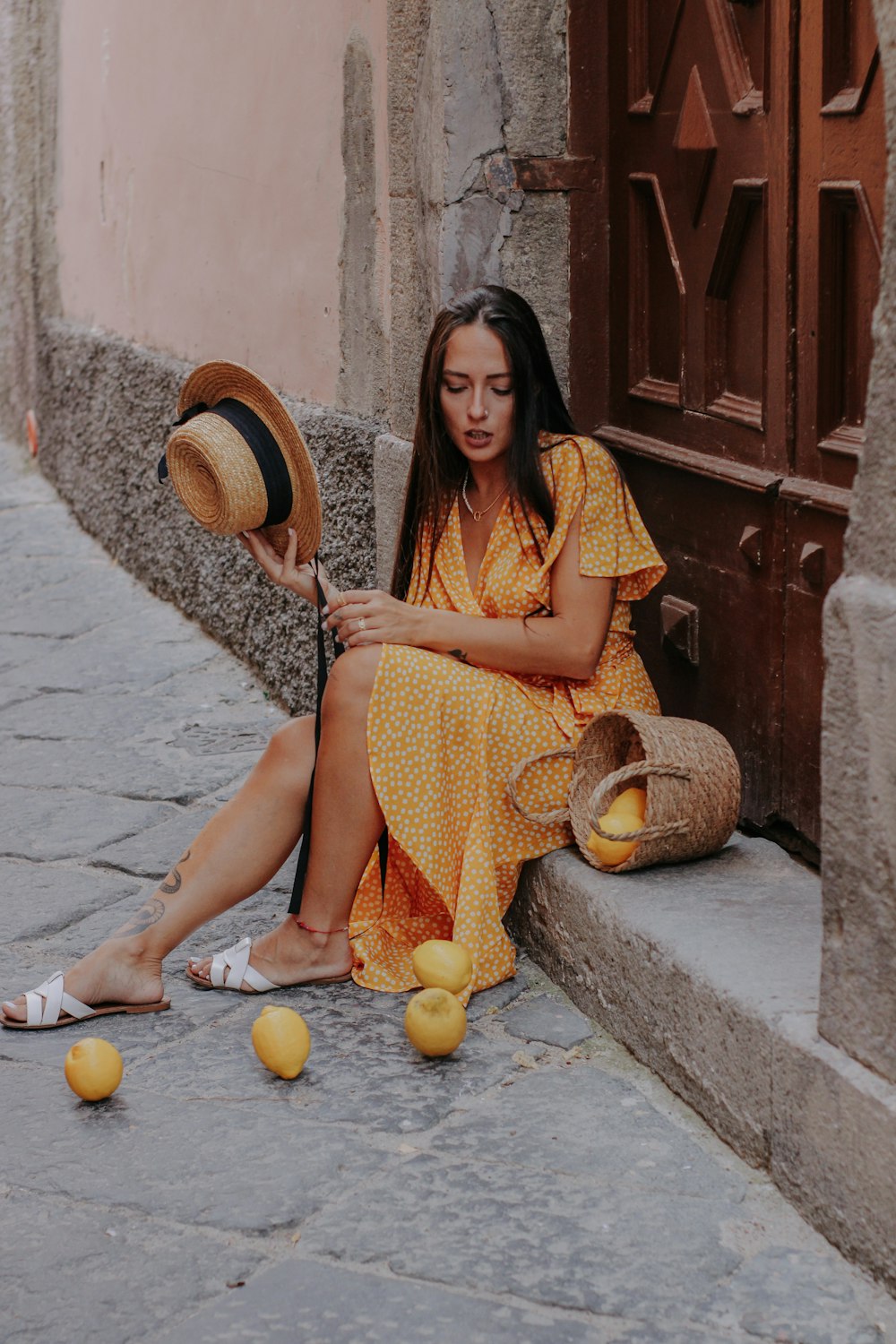 a woman sitting on the steps of a building