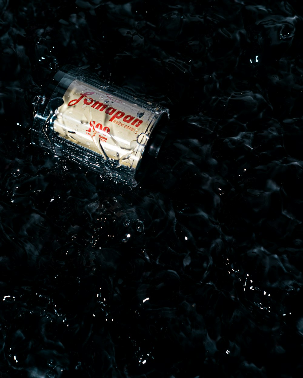 a bottle of champagne sitting on top of a black surface