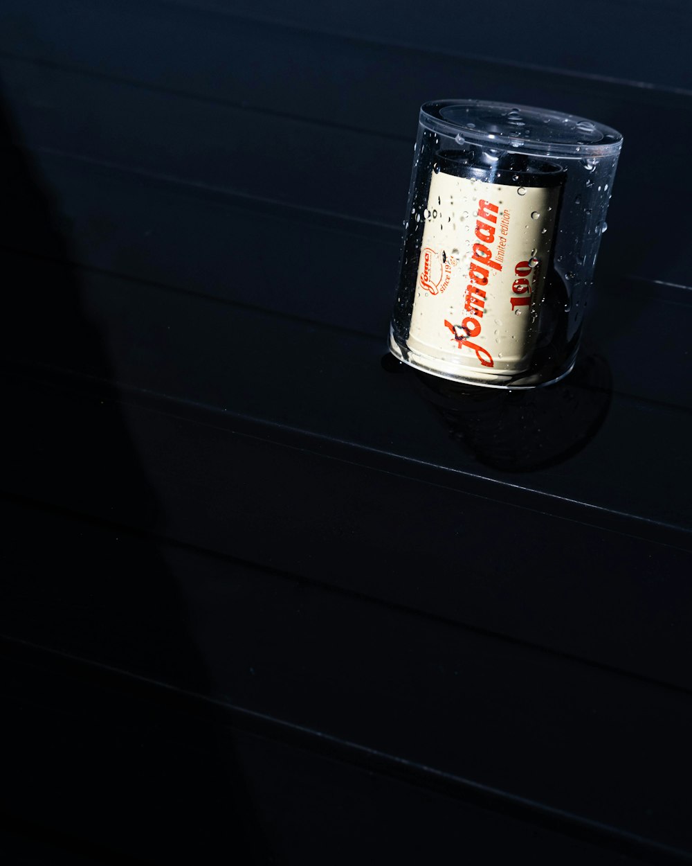 a can of beer sitting on top of a table