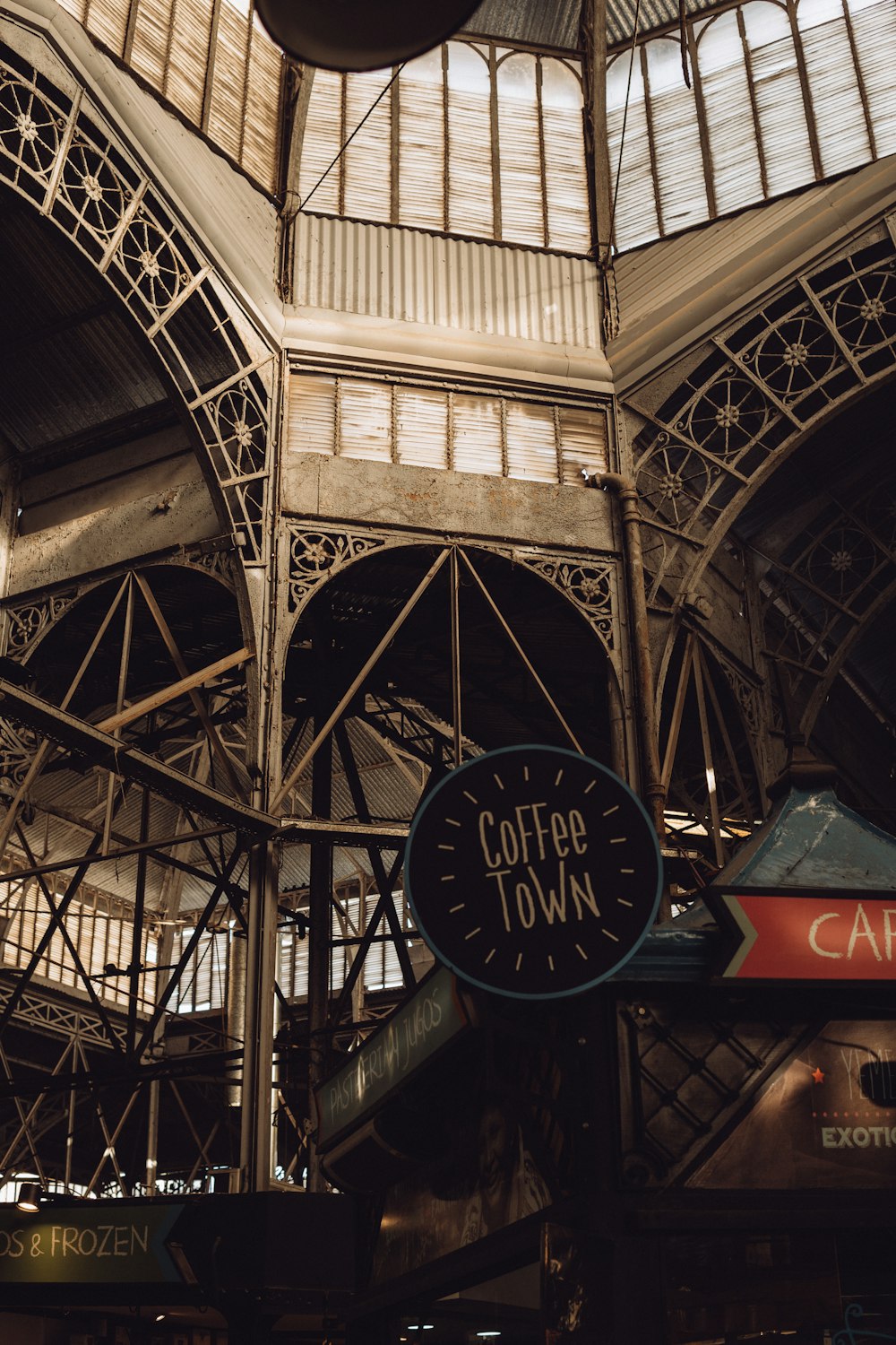 a clock hanging from the ceiling of a building