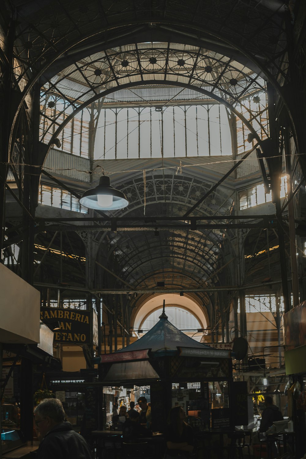 the inside of a train station with people walking around