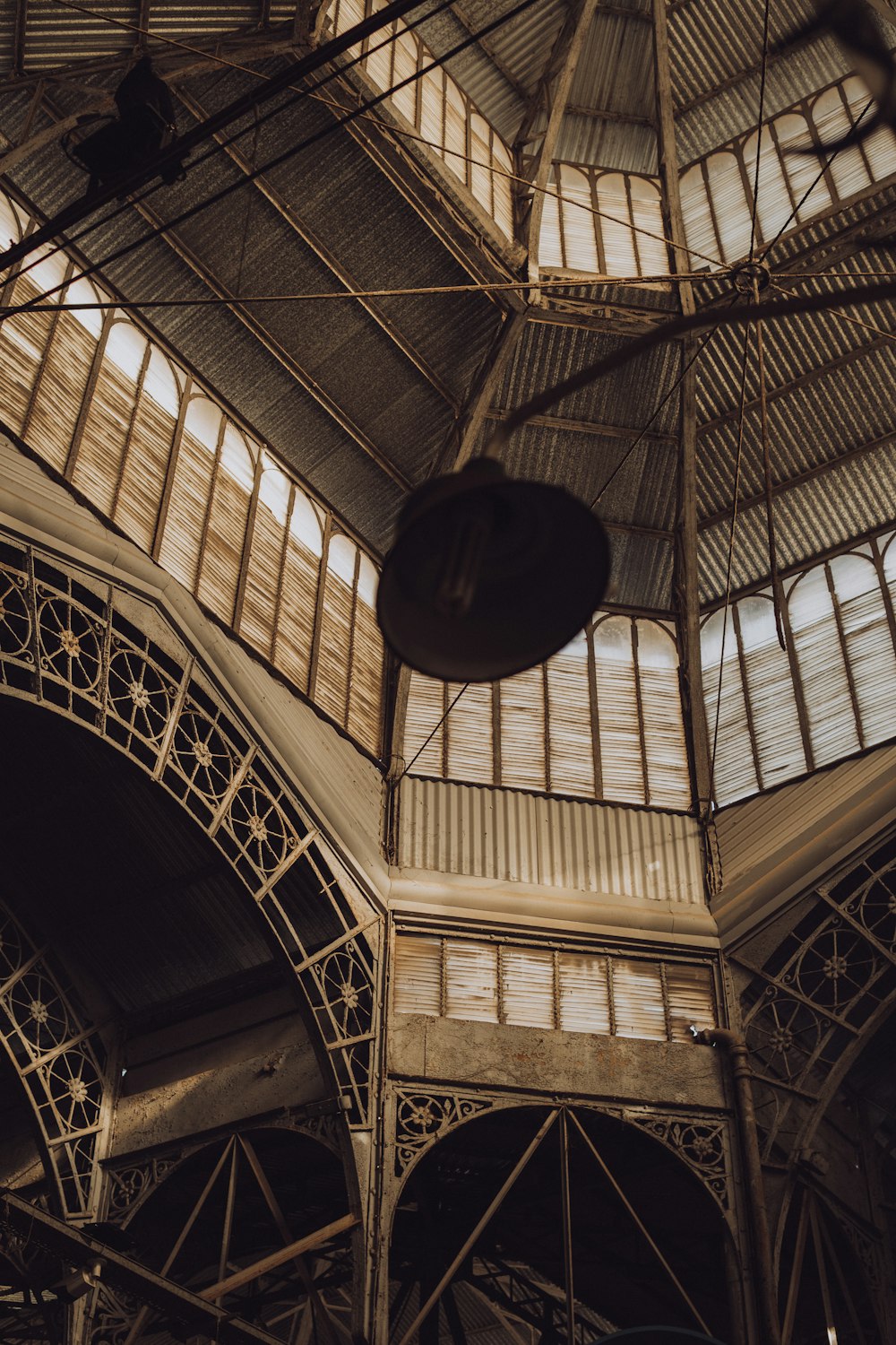 the ceiling of a building with a clock on it