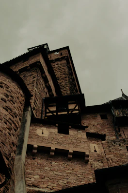 Dark, moody photograph of a medieval castle at dusk.